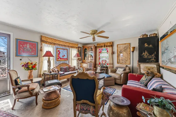 a very nice looking living room with furniture and a large window