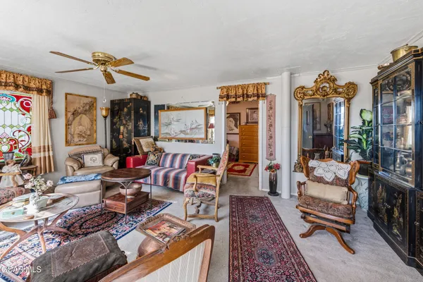a living room filled with furniture and a chandelier