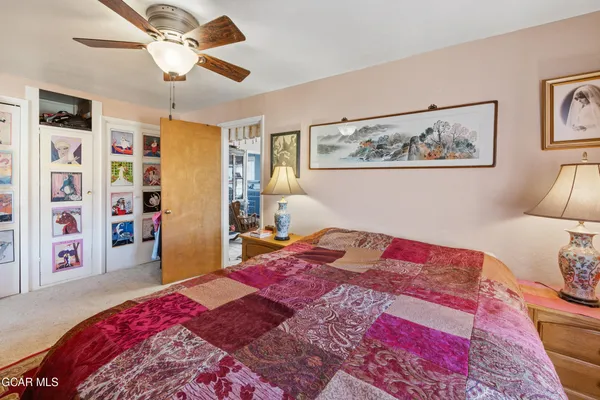 a bedroom with a bed and ceiling fan