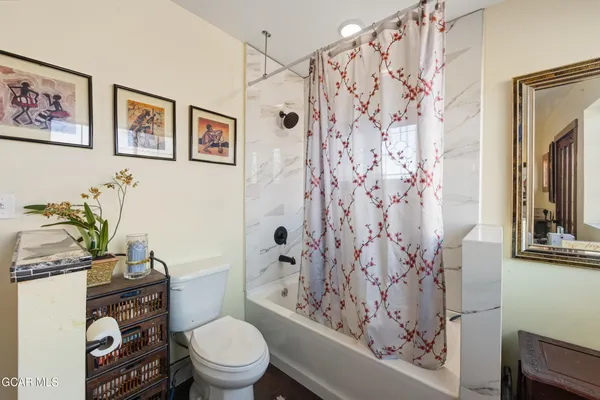 a white toilet sitting next to a bathroom sink