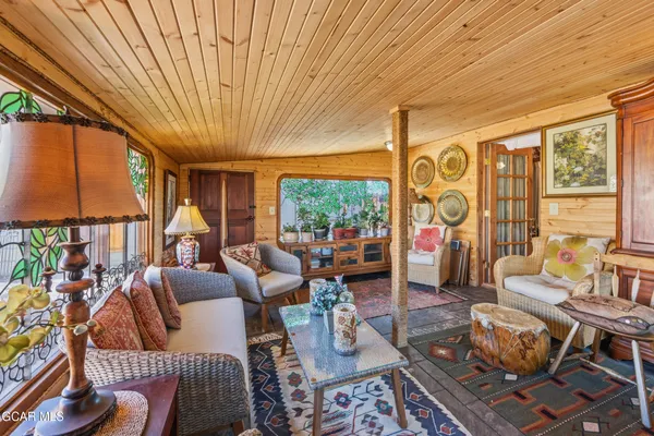 a living room with furniture a rug and a large window