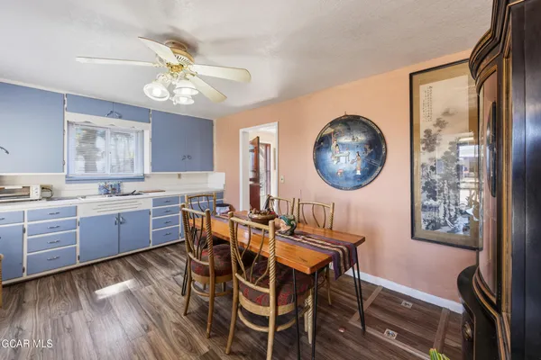 a kitchen with granite countertop a table chairs a stove a dining table and chairs