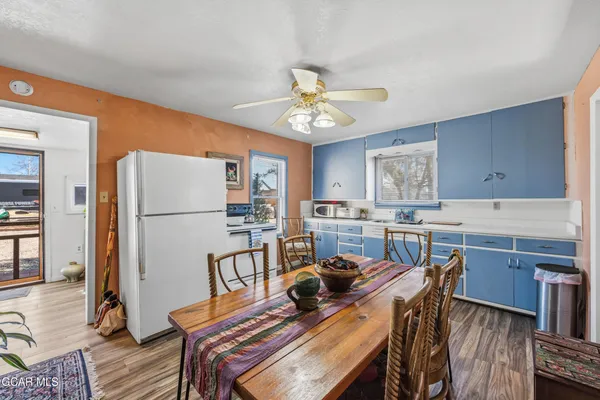 a view of a dining room with furniture and a chandelier