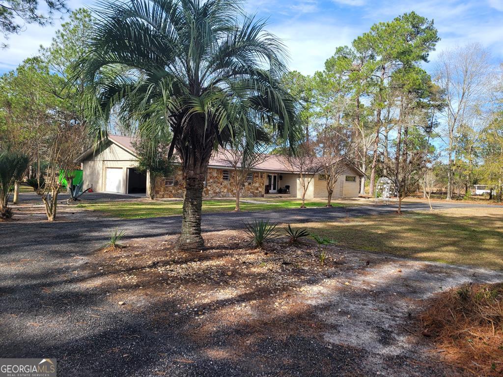 163 Johnson Lake Road Alma, GA 31510 - Photo 1 of 1 a backyard of a house with lots of green space