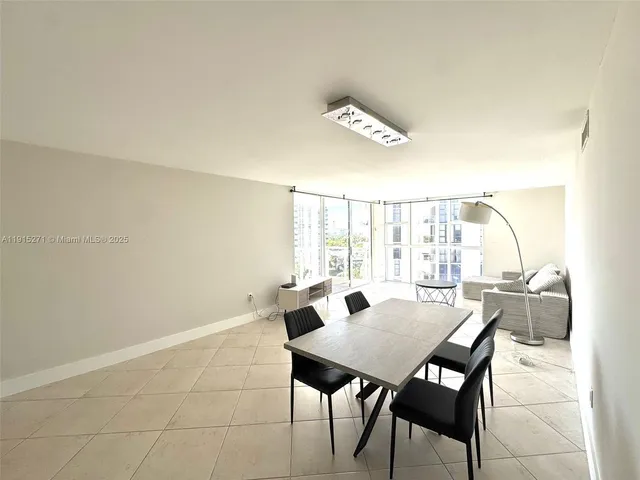 a view of a dining room with furniture and window
