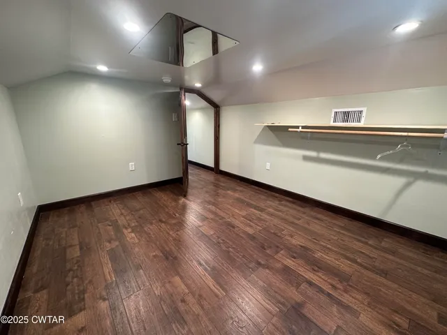 a view of gallery with wooden floor