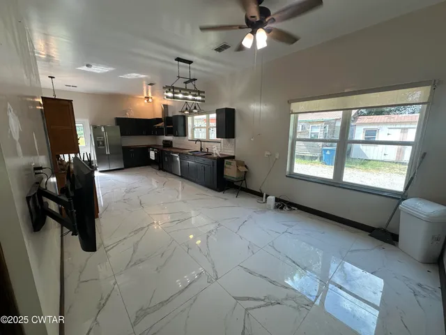 a view of a livingroom with furniture and a window