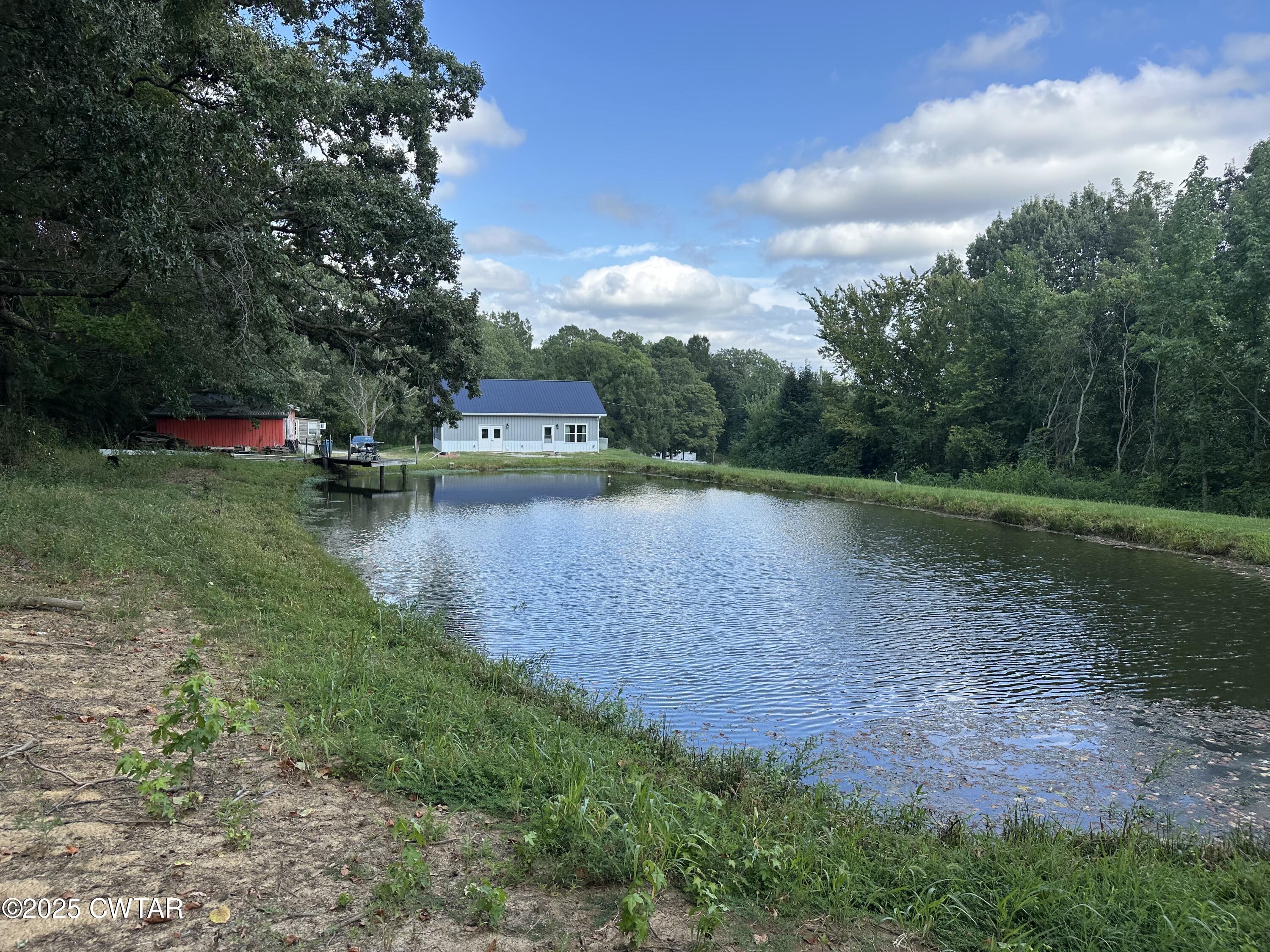 273 Fletcher Road Dyer, TN 38330 - Photo 44 of 46 a view of a lake with houses in the background