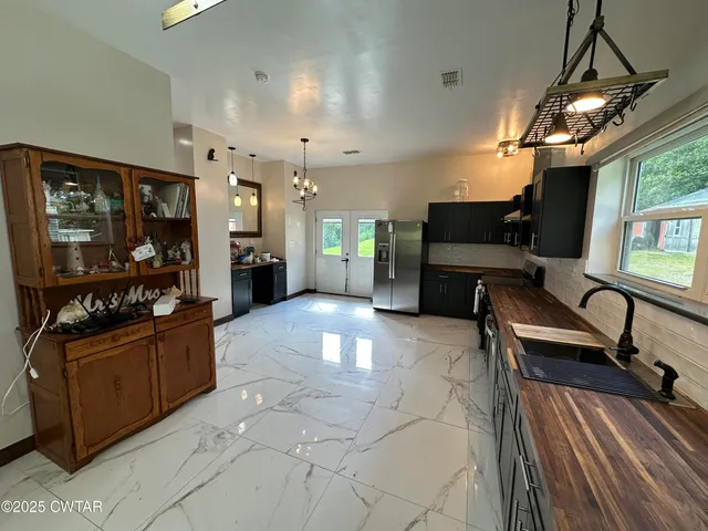 a large living room with stainless steel appliances granite countertop lots of counter top space