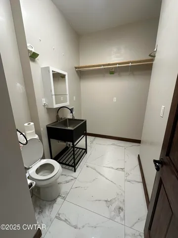 a bathroom with a toilet and a sink
