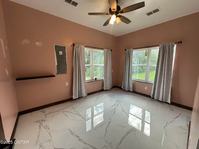 a view of an empty room with a window