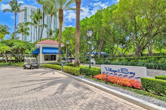 a view of a building with a yard and potted plants