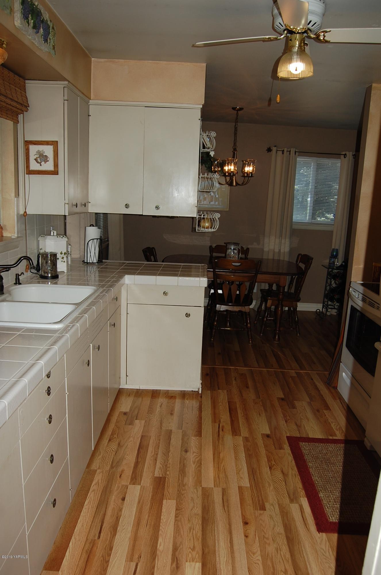 2710 Nelson Road Yakima, WA 98903 - Photo 11 of 30 a kitchen with a sink and wooden floor