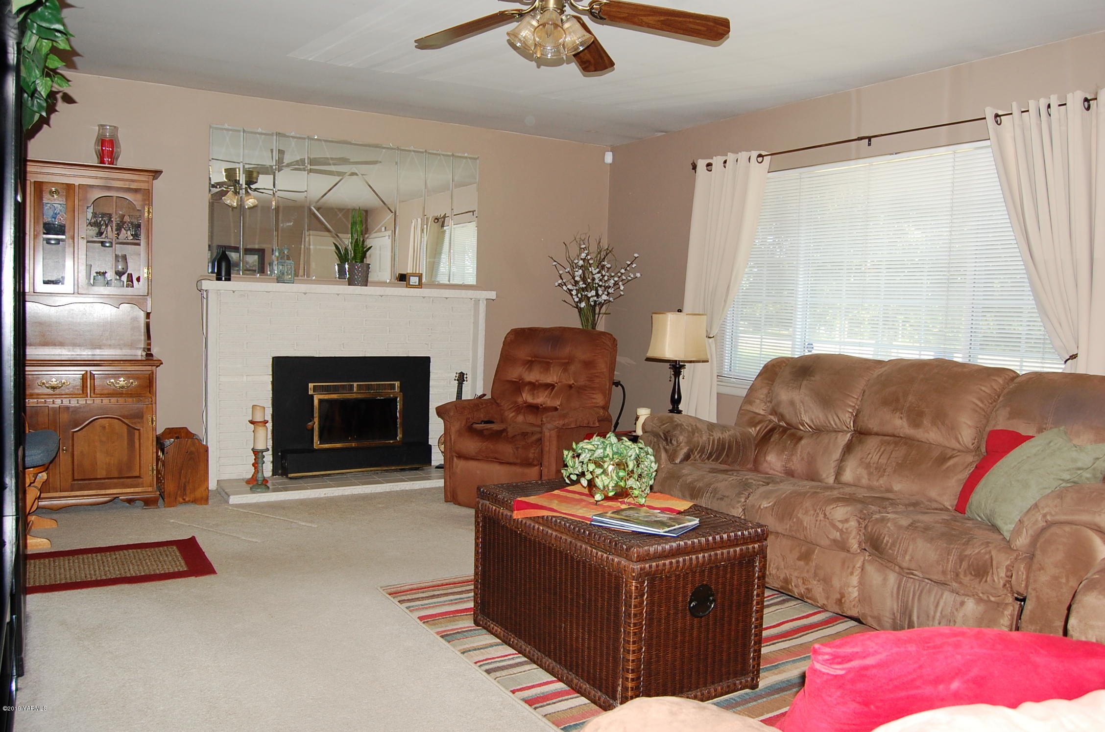 2710 Nelson Road Yakima, WA 98903 - Photo 6 of 30 a living room with furniture and a fireplace