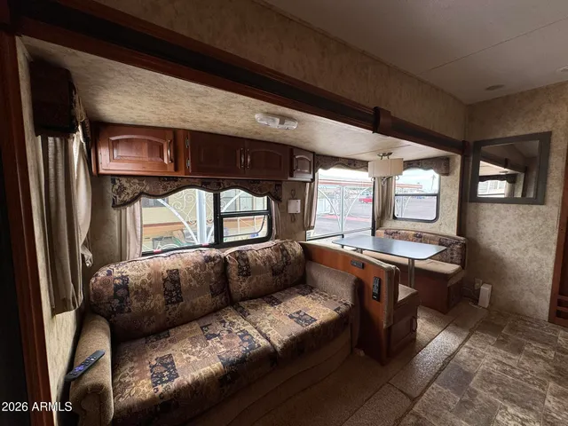 a room with lots of furniture and a wooden floor