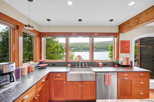 a kitchen with stainless steel appliances sink large window and cabinets