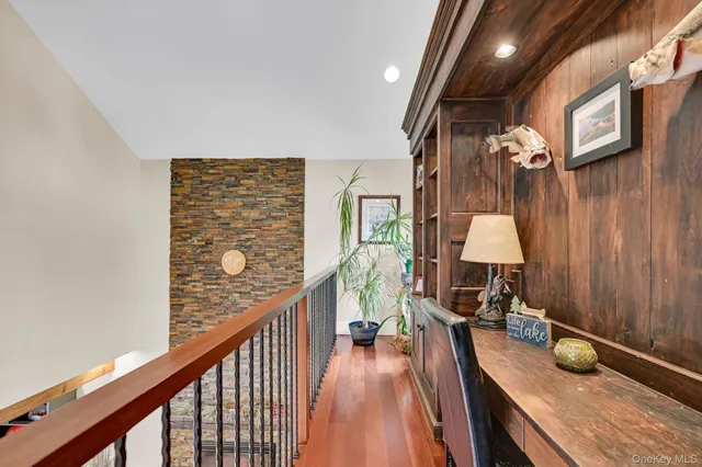 a view of a hallway with furniture and floor to ceiling window