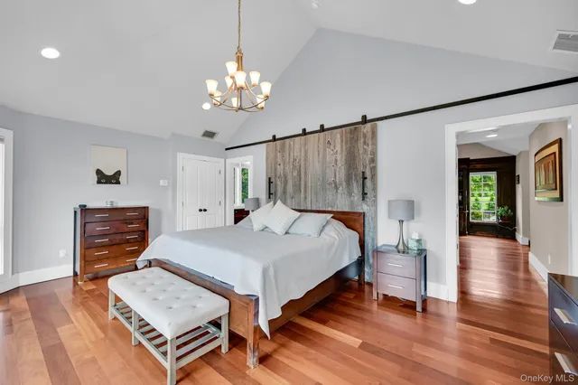 a spacious bedroom with a bed and a large window