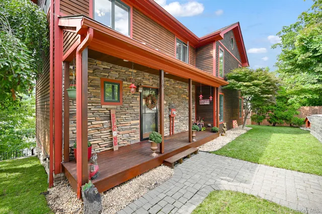 a view of a house with backyard and porch