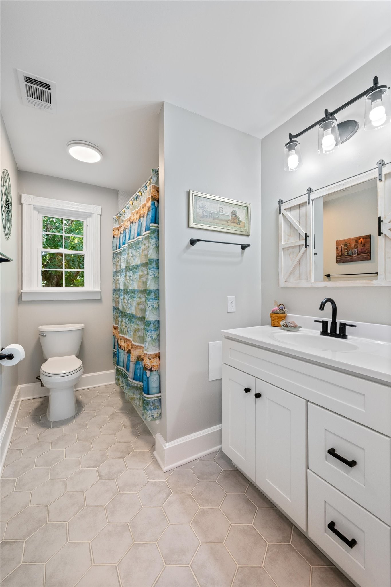 6395 Huffman Road Goodlettsville, TN 37072 - Photo 20 of 38 a spacious bathroom with a double vanity sink a toilet and a window