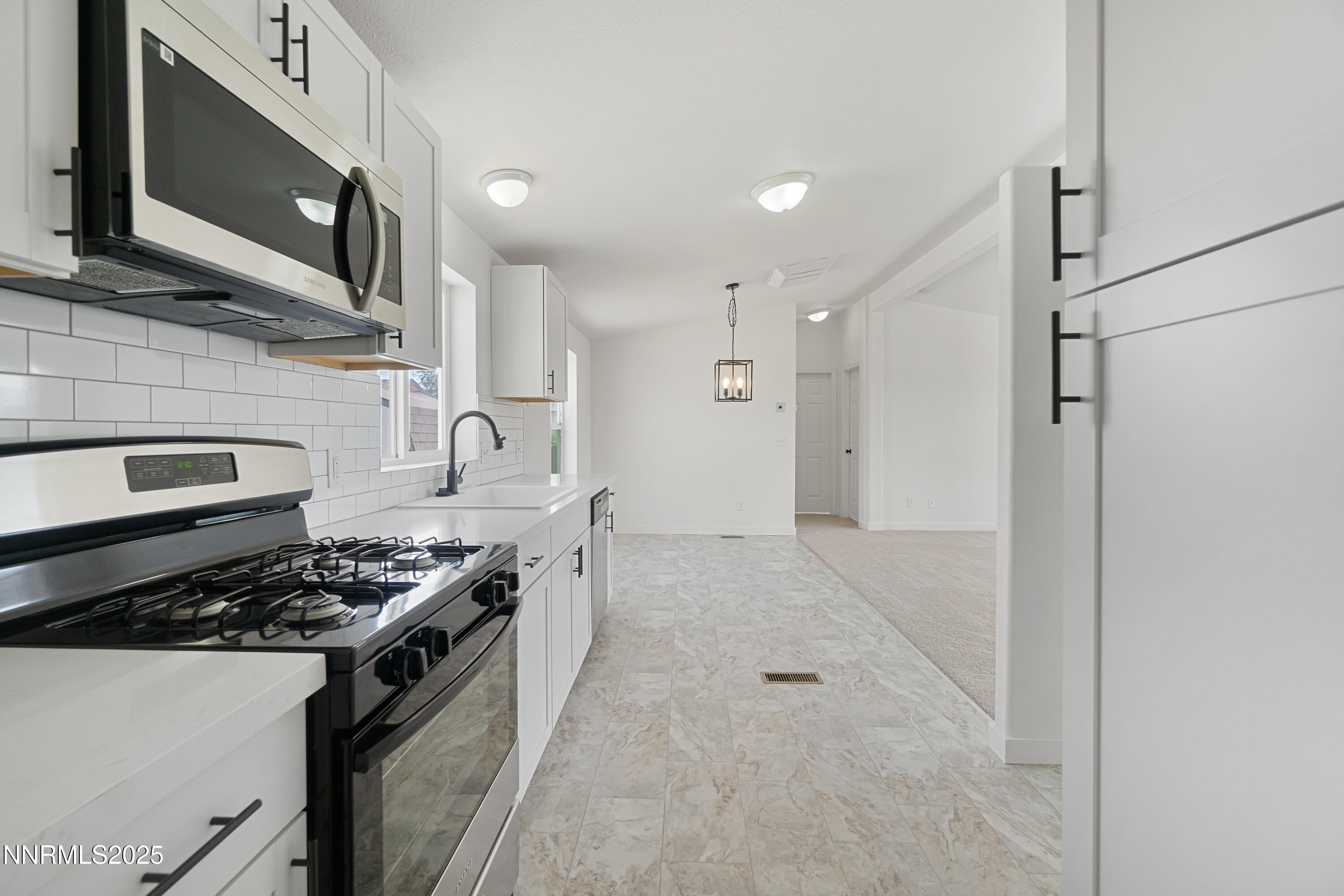 863 Jennys Lane Fernley, NV 89408 - Photo 14 of 24 a kitchen with stainless steel appliances granite countertop a stove and a microwave