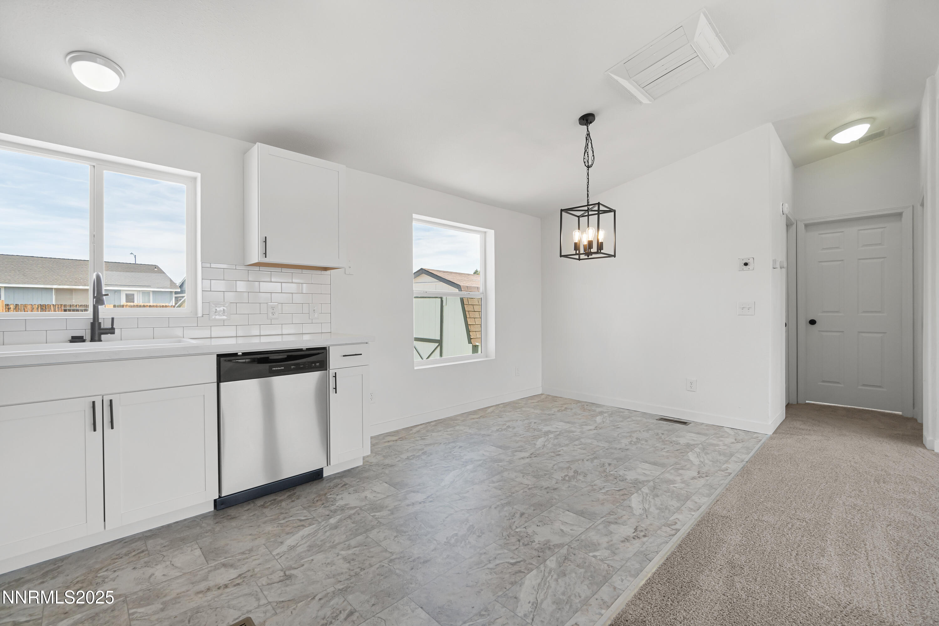 863 Jennys Lane Fernley, NV 89408 - Photo 9 of 24 a kitchen with granite countertop white cabinets and white appliances