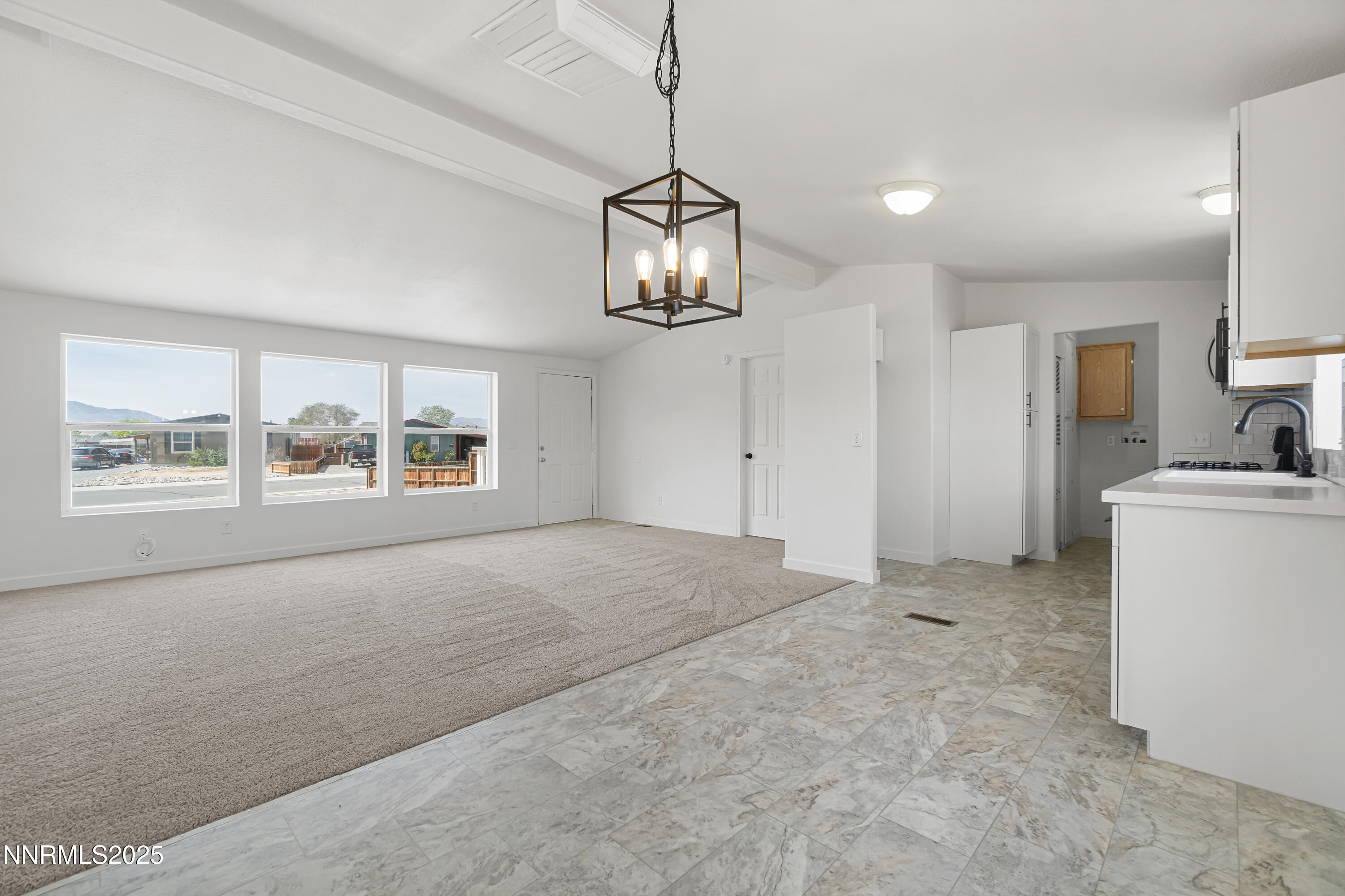 863 Jennys Lane Fernley, NV 89408 - Photo 10 of 24 a big room with windows and chandelier