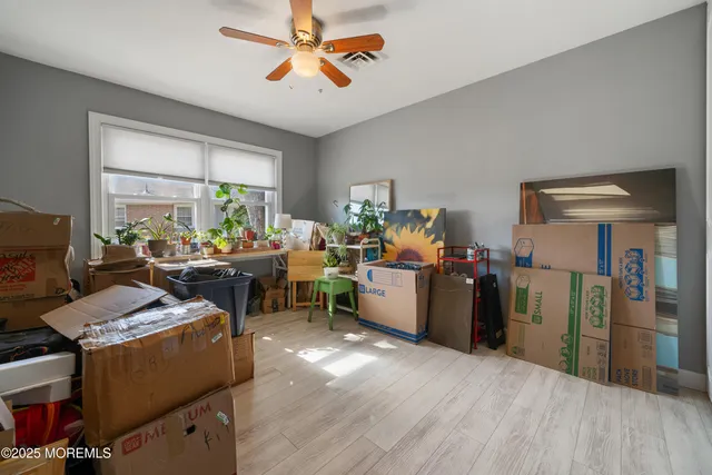 a room with furniture a window and wooden floor