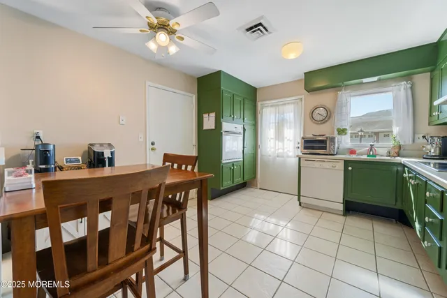 a kitchen with a table and chairs