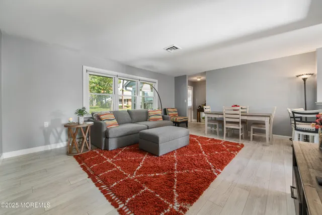 a living room with furniture a rug and a table