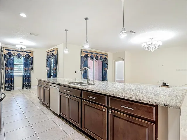 a bathroom with a granite countertop double vanity and a mirror