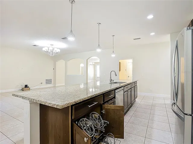 a bathroom with a granite countertop double vanity sink and a mirror