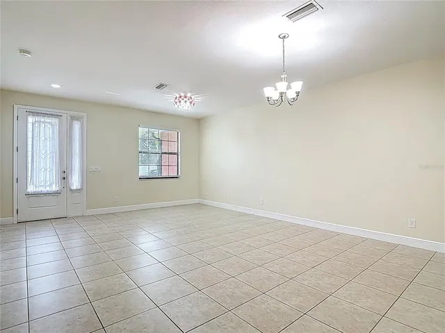 a kitchen with a sink a faucet a chandelier and living room view