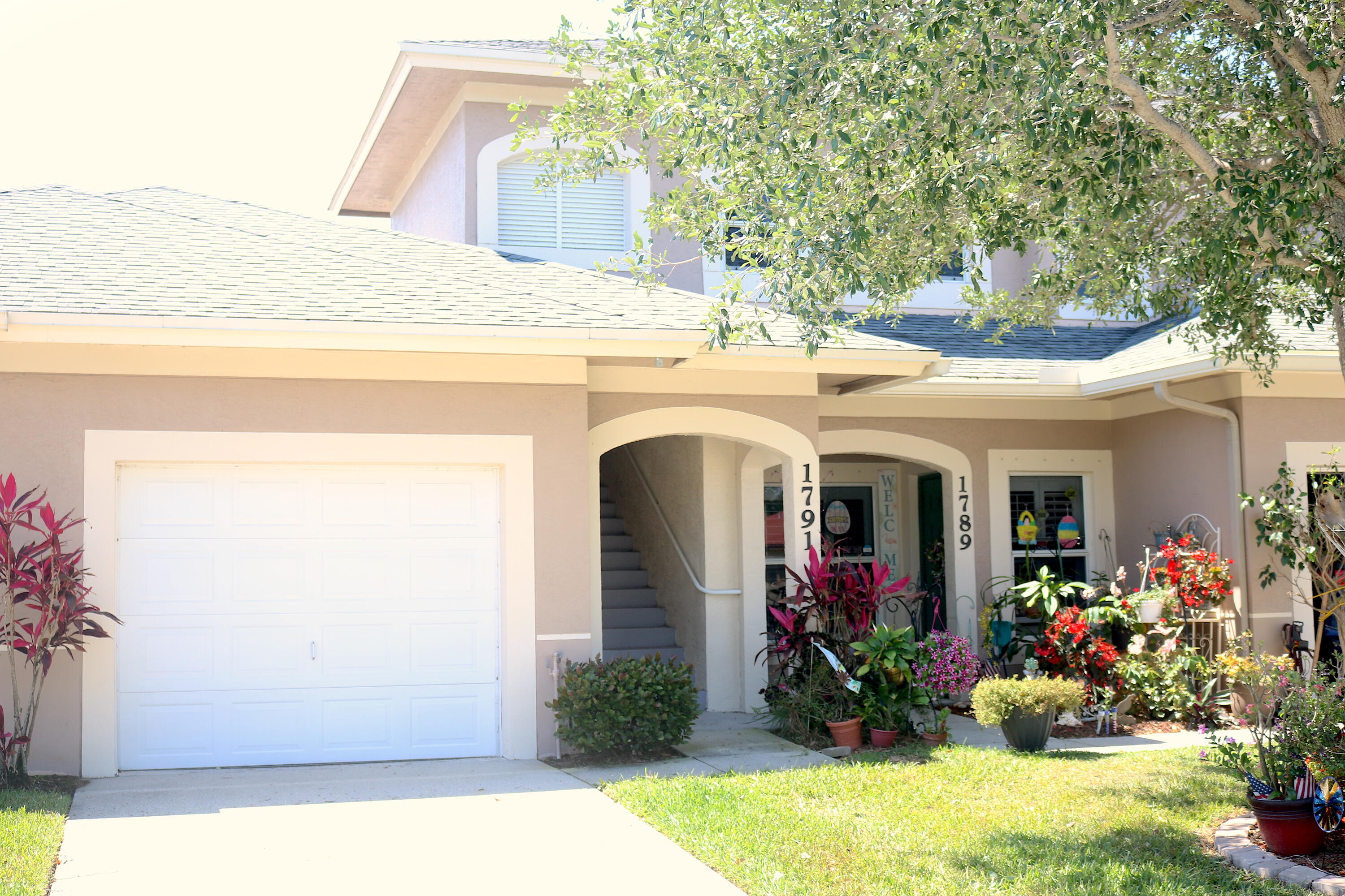1791 Lakefront Boulevard, Unit 1 Fort Pierce, FL 34982 - Photo 1 of 14 a view of a house with large windows and a yard