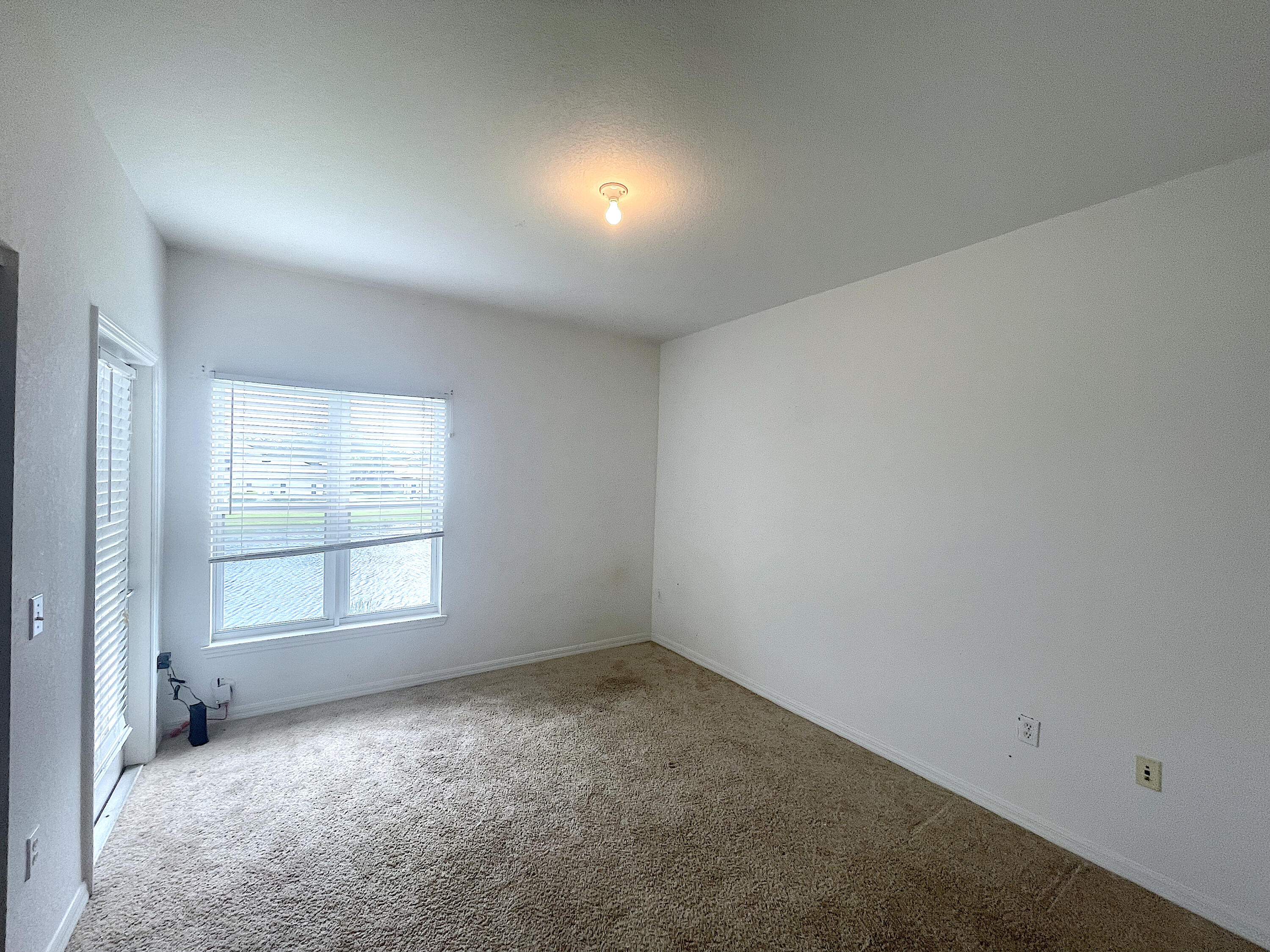 1791 Lakefront Boulevard, Unit 1 Fort Pierce, FL 34982 - Photo 11 of 14 an empty room with a empty space and windows