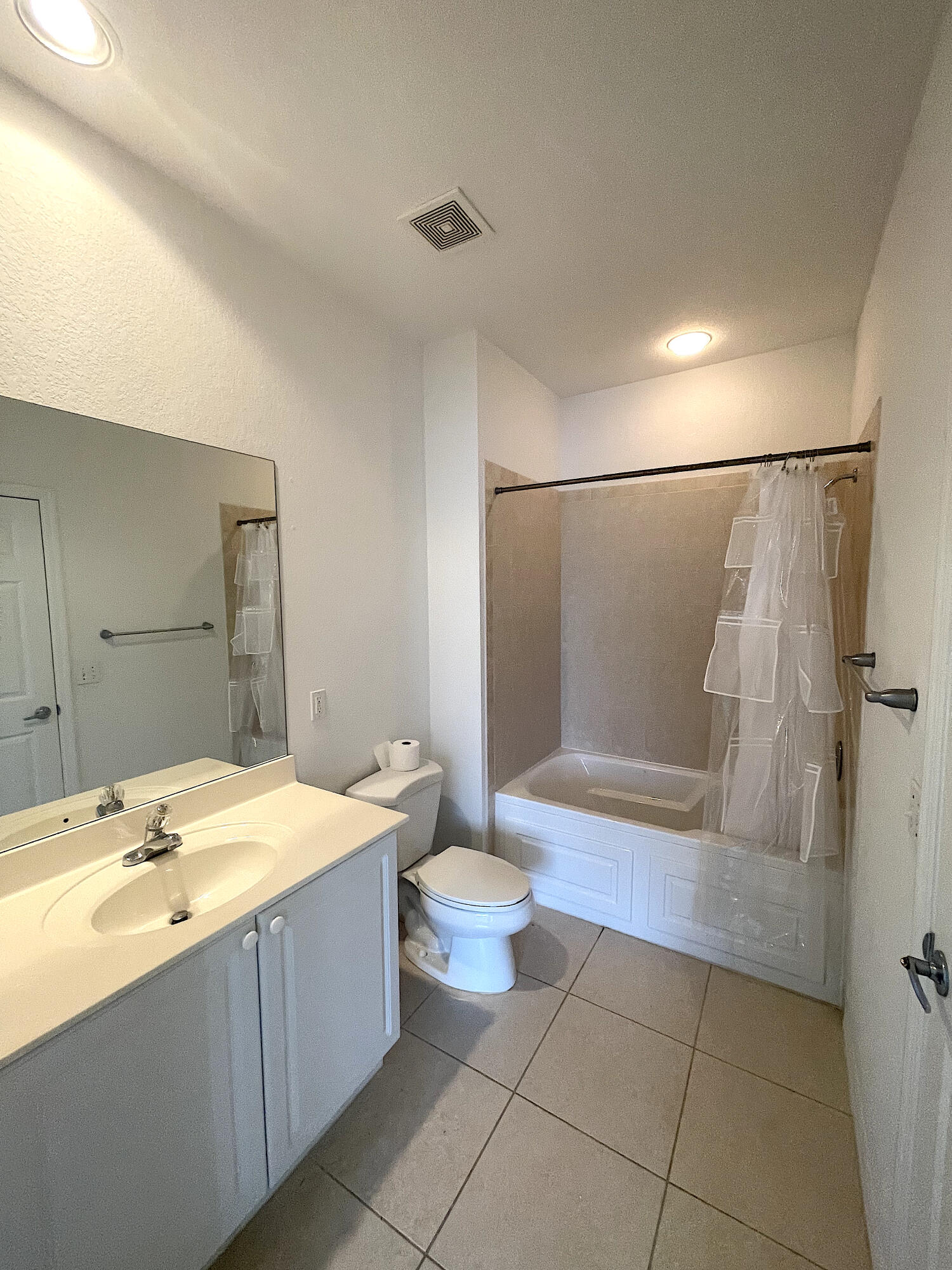 1791 Lakefront Boulevard, Unit 1 Fort Pierce, FL 34982 - Photo 12 of 14 a bathroom with a tub sink and a mirror