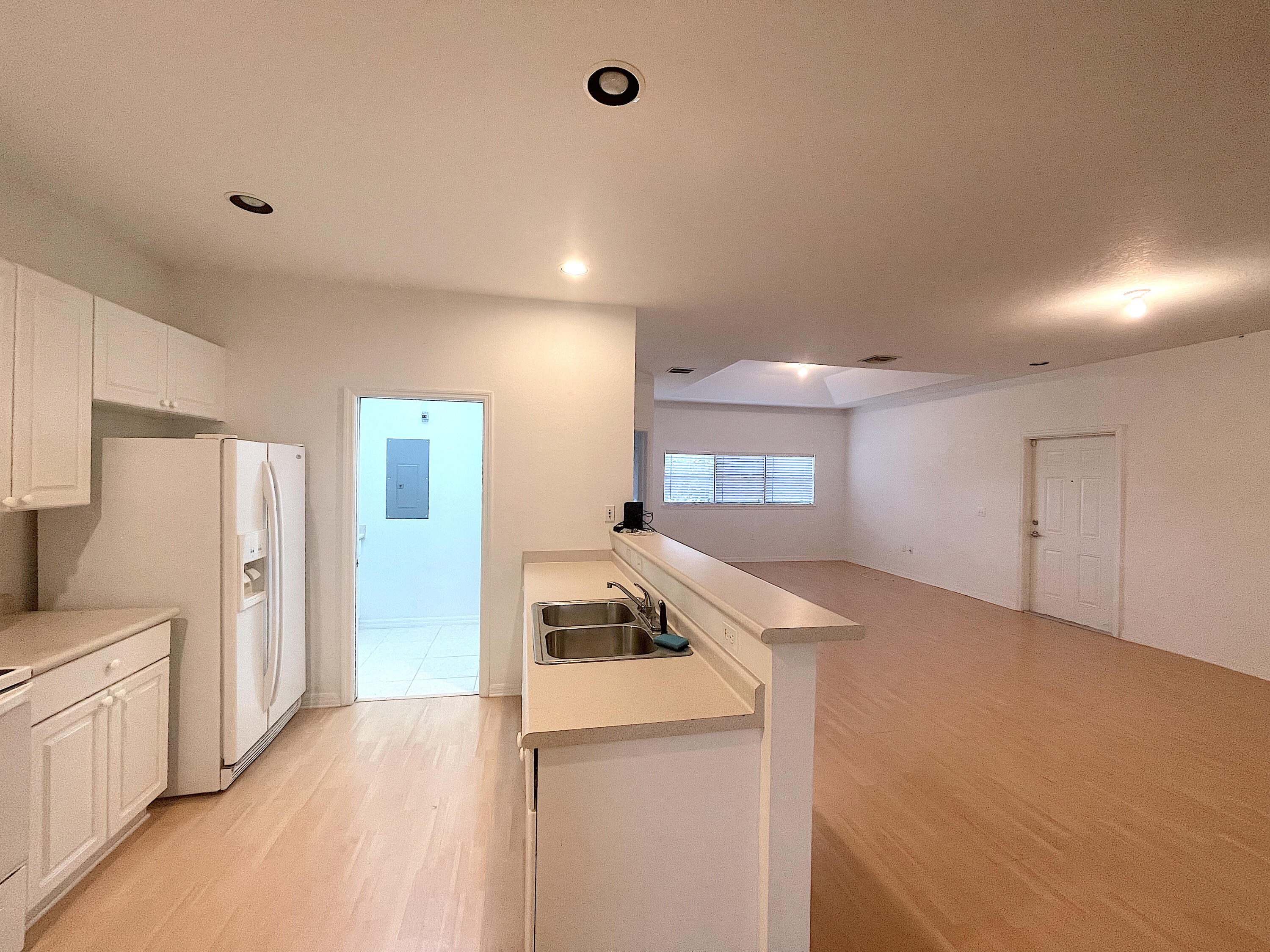 1791 Lakefront Boulevard, Unit 1 Fort Pierce, FL 34982 - Photo 4 of 14 a kitchen with a refrigerator a stove top oven a sink and dishwasher