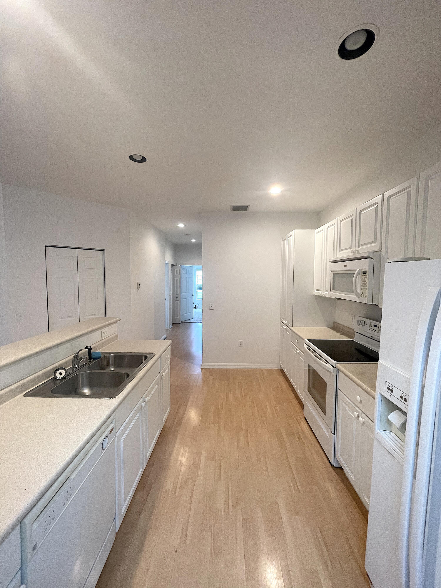 1791 Lakefront Boulevard, Unit 1 Fort Pierce, FL 34982 - Photo 6 of 14 a kitchen with granite countertop a sink and cabinets