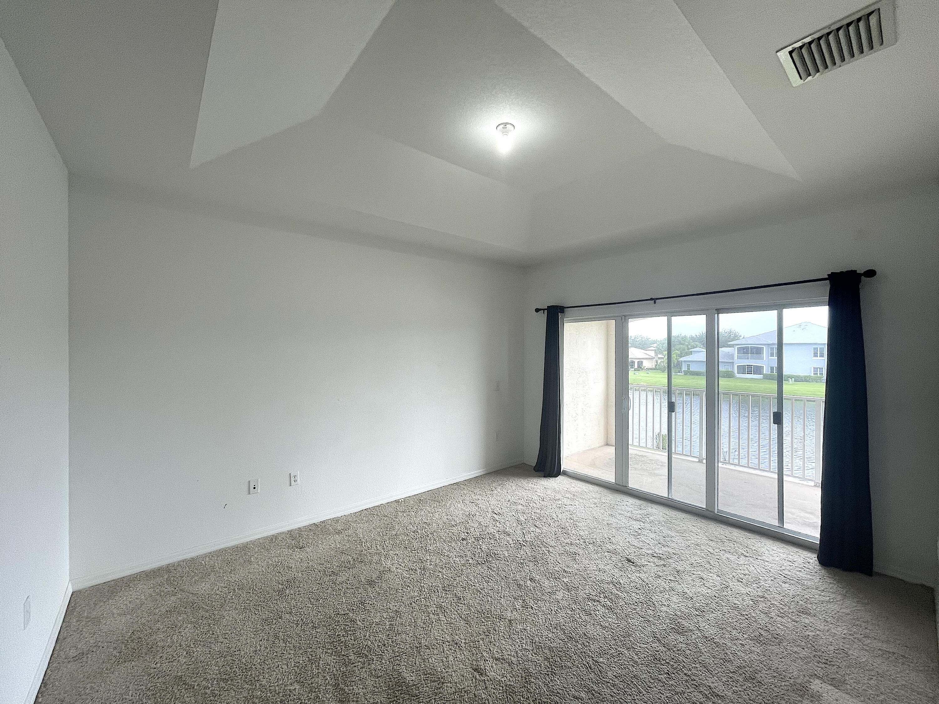 1791 Lakefront Boulevard, Unit 1 Fort Pierce, FL 34982 - Photo 9 of 14 a view of an empty room with a balcony