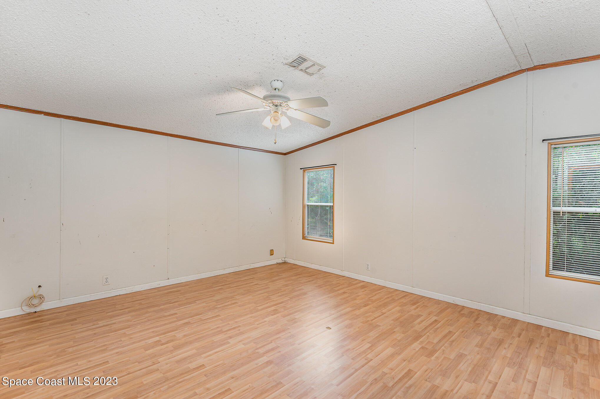 823 Phyllis Way Cocoa, FL 32926 - Photo 11 of 28 an empty room with a window and a ceiling fan