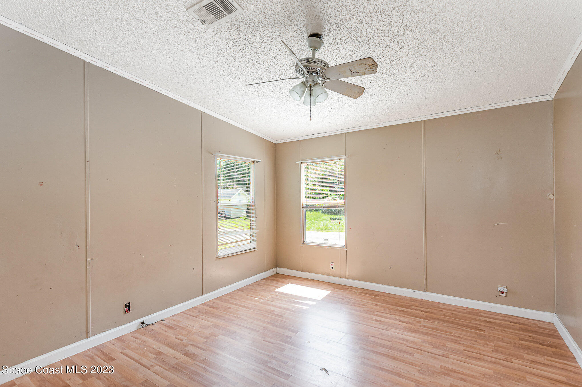 823 Phyllis Way Cocoa, FL 32926 - Photo 14 of 28 a view of an empty room with wooden floor and a window
