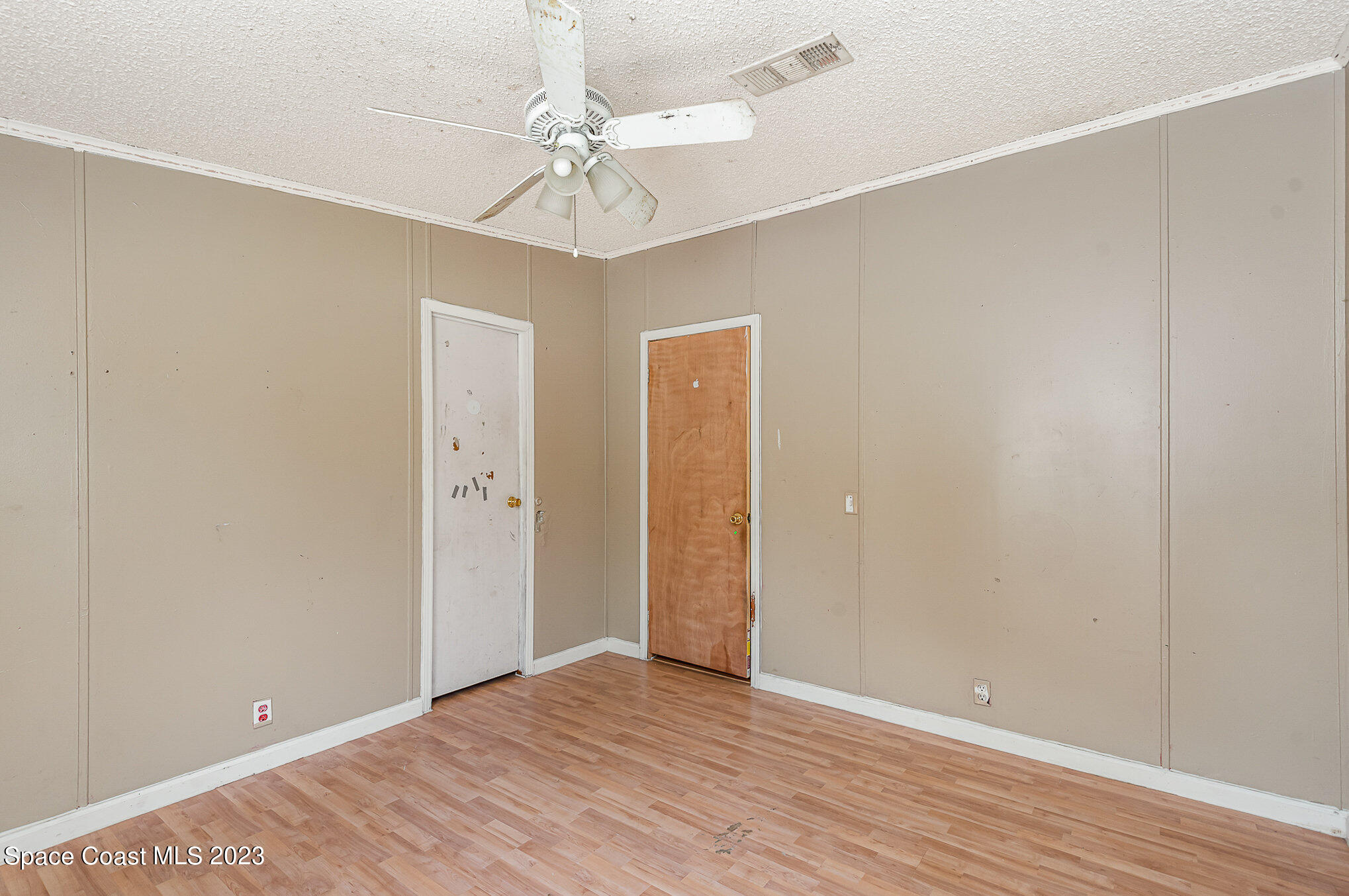 823 Phyllis Way Cocoa, FL 32926 - Photo 15 of 28 a view of an empty room with wooden floor