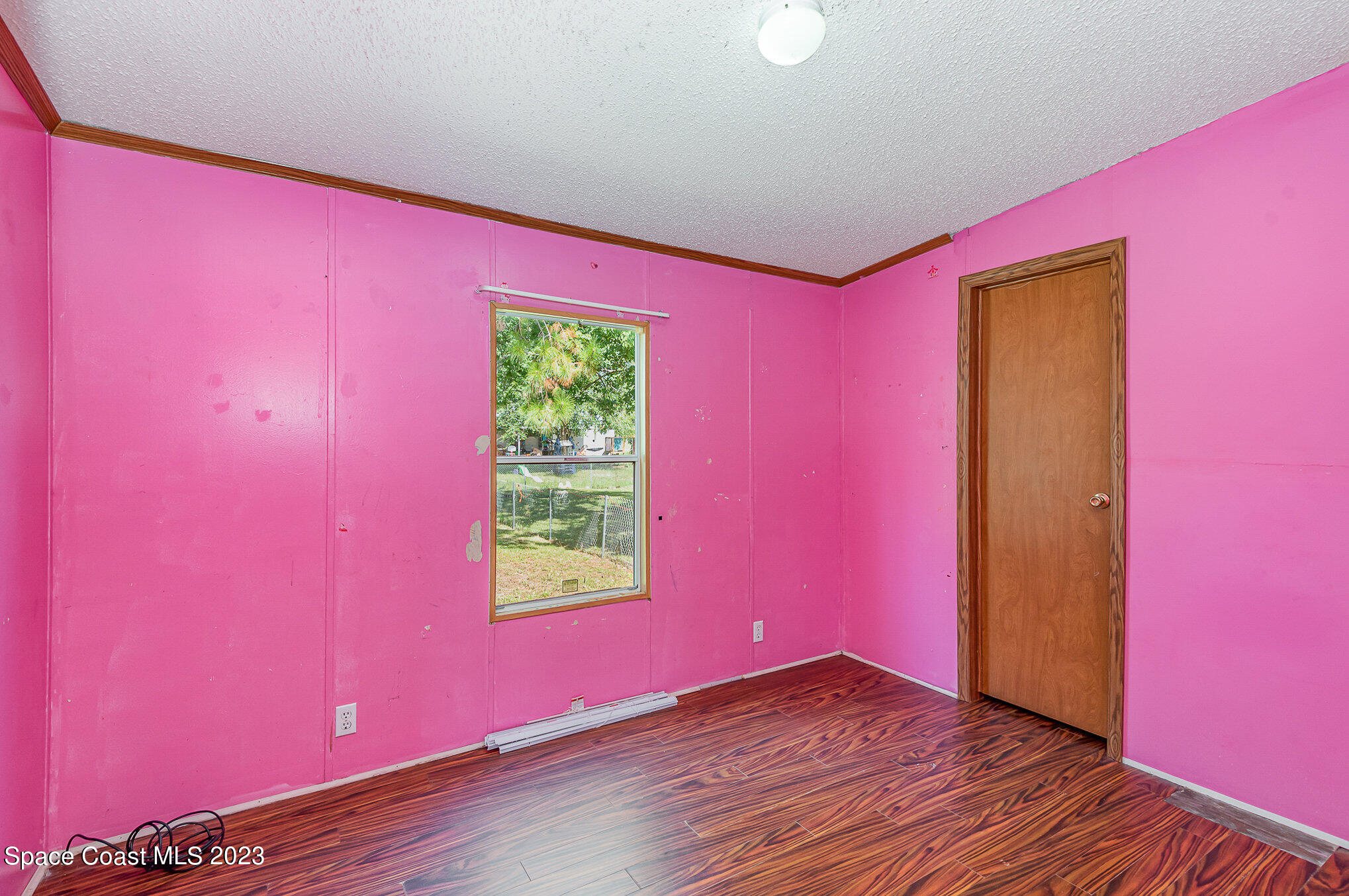 823 Phyllis Way Cocoa, FL 32926 - Photo 16 of 28 a view of empty room with wooden floor and fan