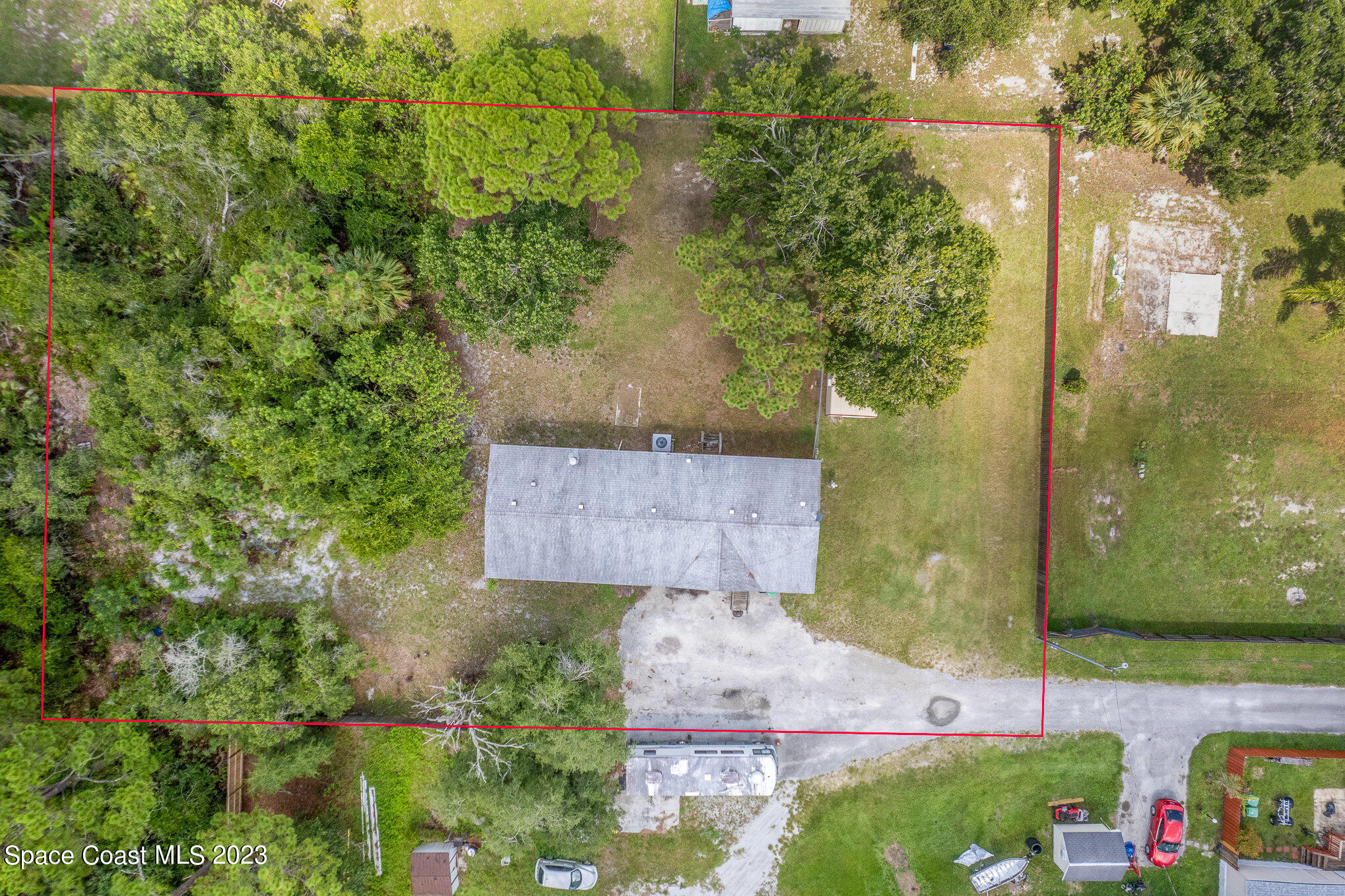 823 Phyllis Way Cocoa, FL 32926 - Photo 25 of 28 an aerial view of a house with a yard and large tree