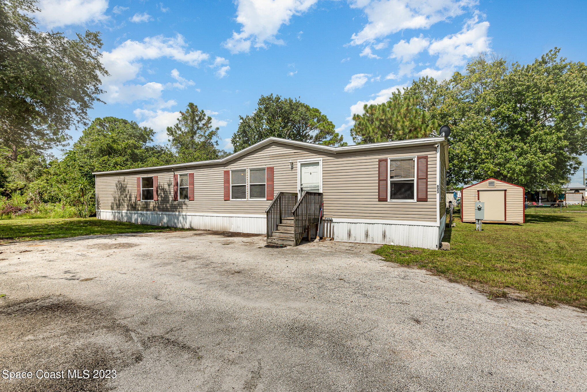 823 Phyllis Way Cocoa, FL 32926 - Photo 3 of 28 a view of a house with backyard and a tree