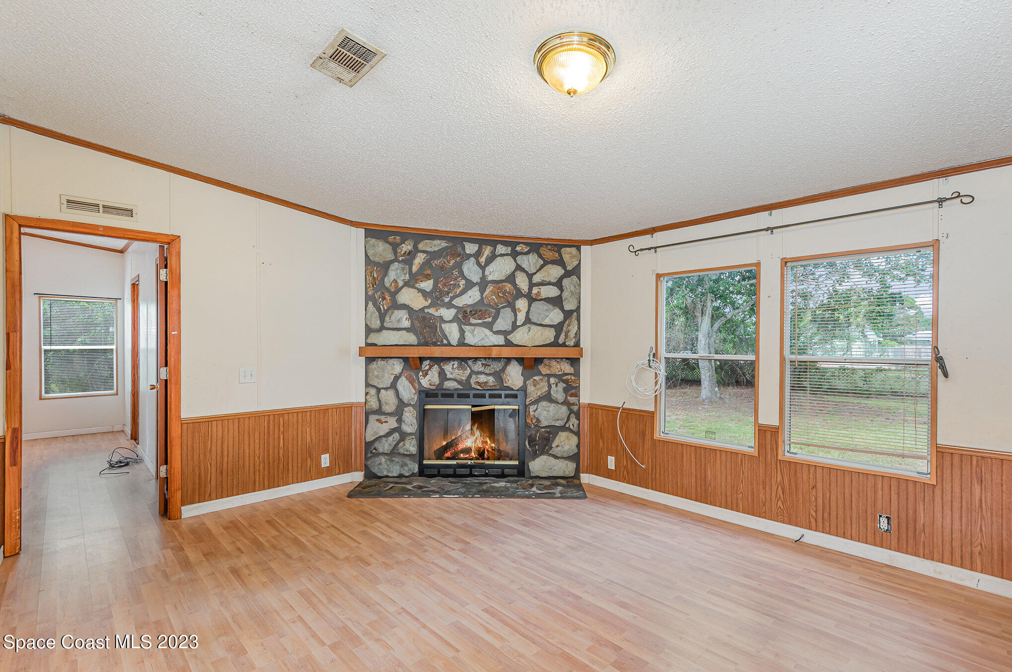823 Phyllis Way Cocoa, FL 32926 - Photo 5 of 28 a view of empty room with wooden floor and fan