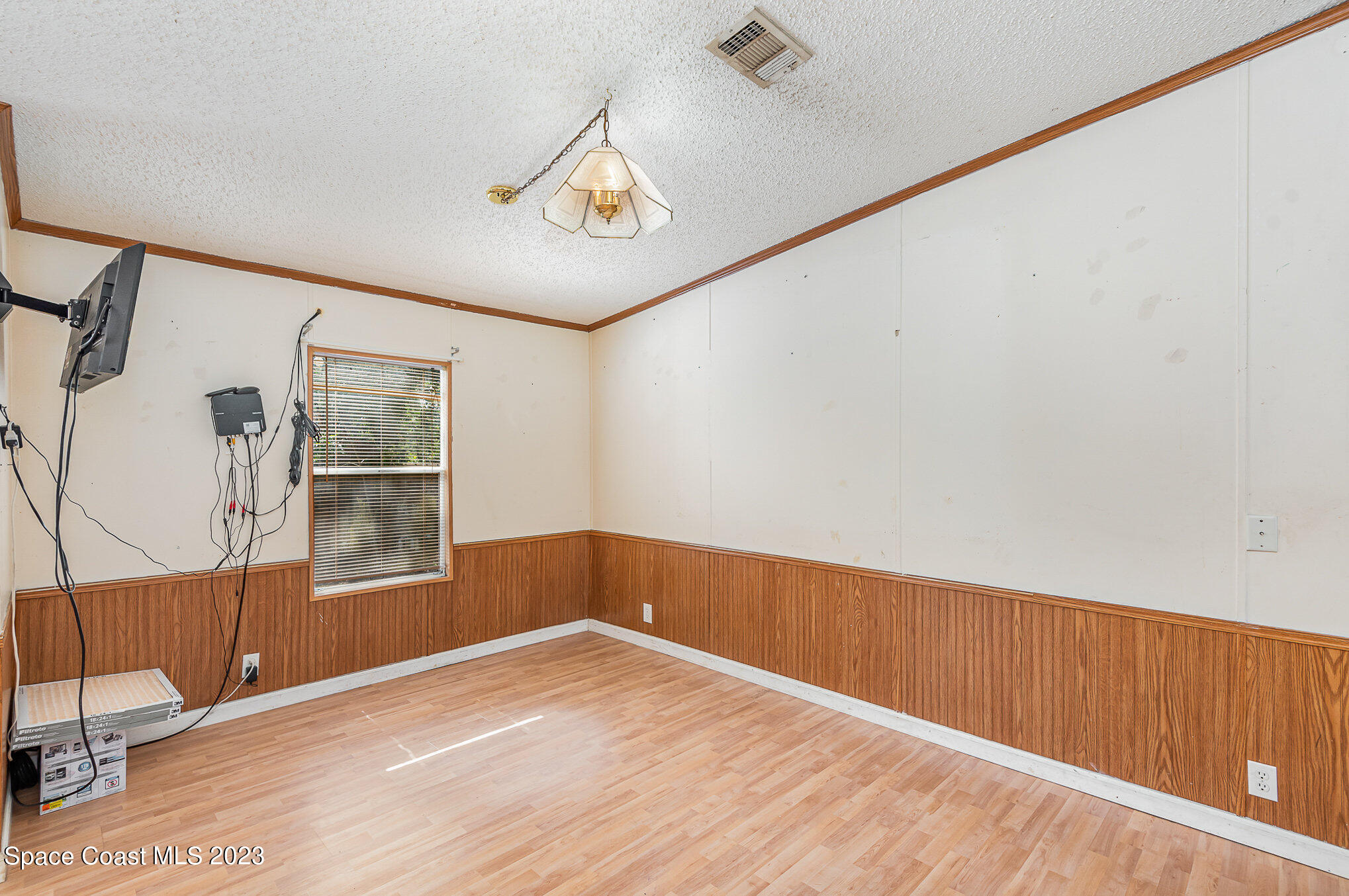 823 Phyllis Way Cocoa, FL 32926 - Photo 7 of 28 a view of an empty room with wooden floor and a window