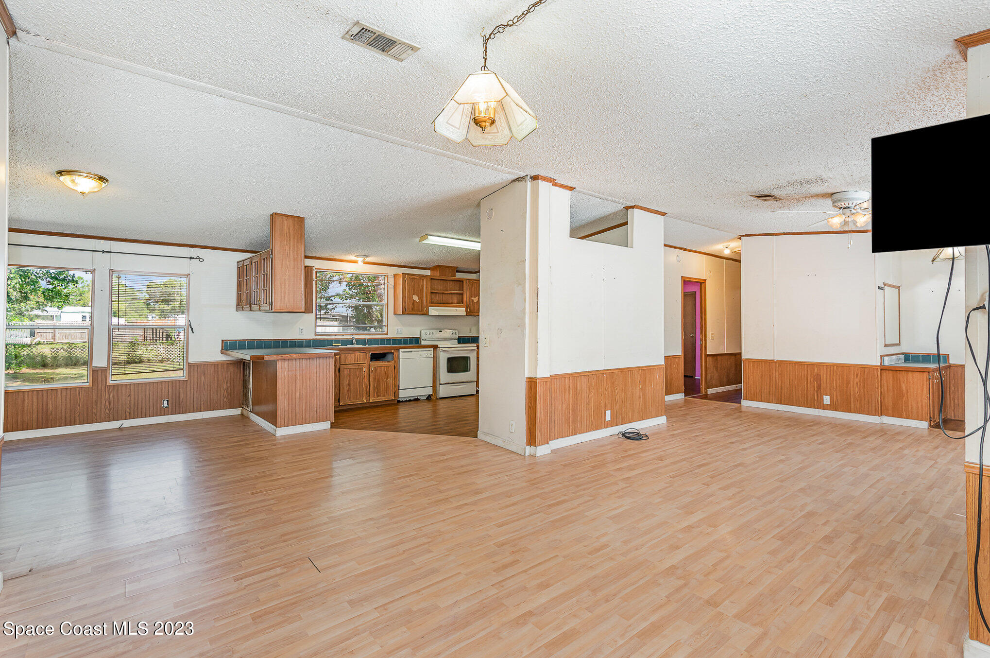 823 Phyllis Way Cocoa, FL 32926 - Photo 8 of 28 a view of a kitchen and a stove wooden floor windows