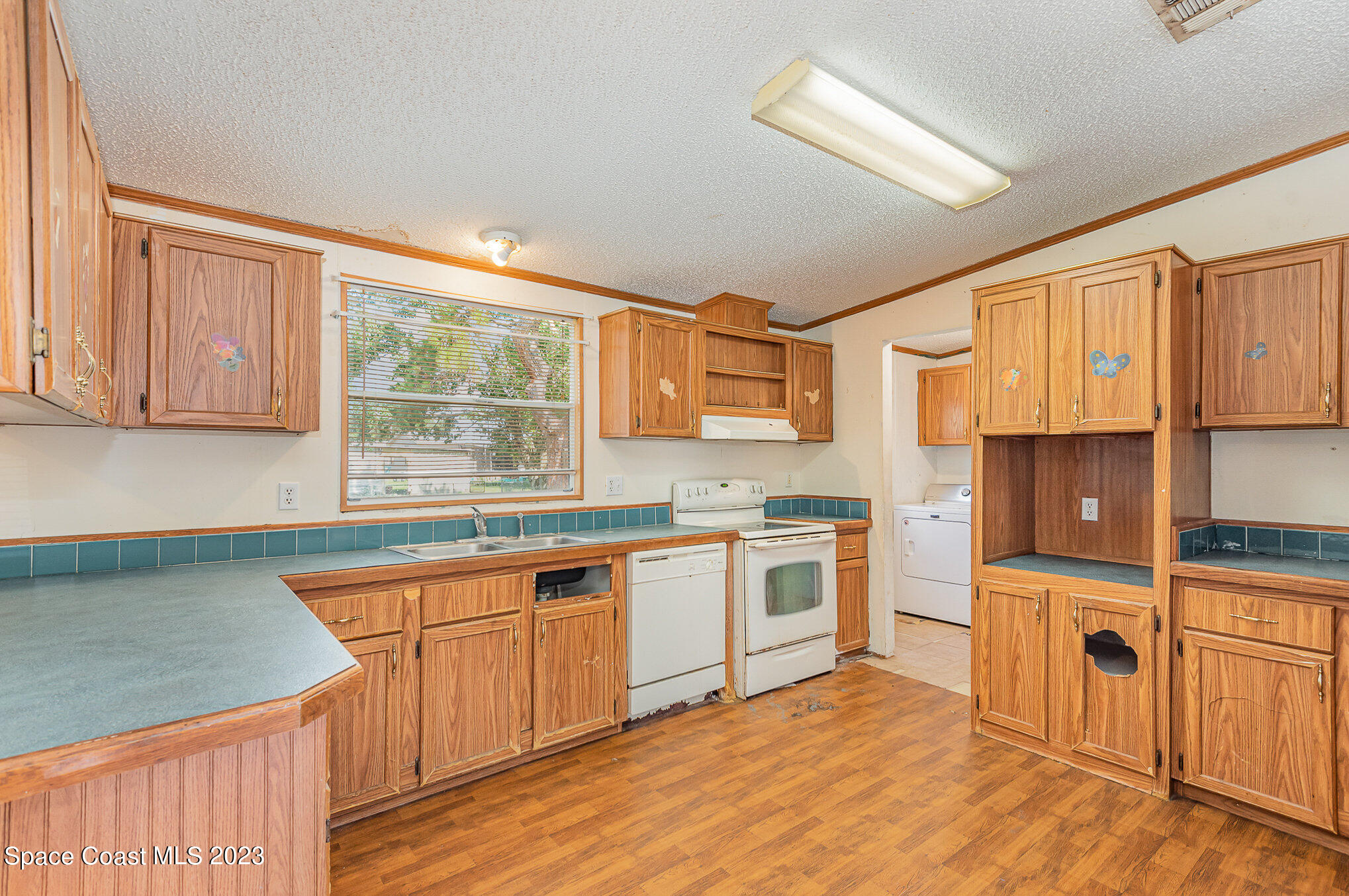 823 Phyllis Way Cocoa, FL 32926 - Photo 10 of 28 a kitchen with stainless steel appliances granite countertop a stove a sink and a microwave
