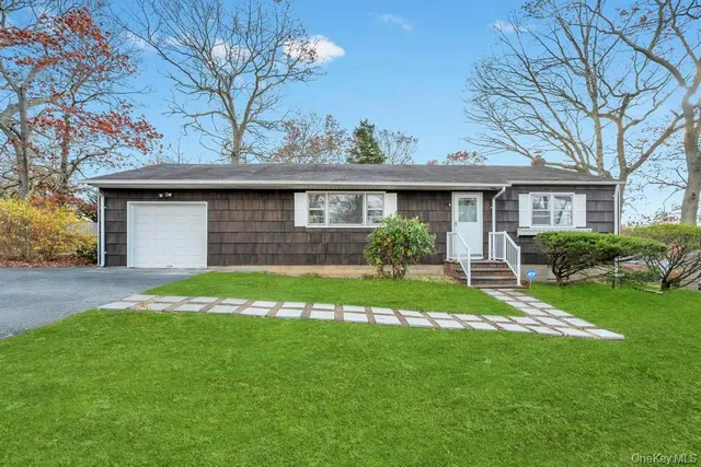 a front view of a house with a garden